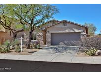 Charming single-story home with desert landscaping and a two-car garage at 27174 N 85Th Dr, Peoria, AZ 85383