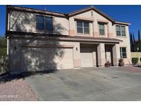 Two-story house with a large driveway and neutral color scheme at 3314 W Dynamite Blvd, Phoenix, AZ 85083