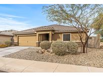 Charming single-story home with a well-manicured front yard and low-maintenance desert landscaping at 442 W Black Hawk Pl, Casa Grande, AZ 85122