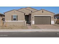 Inviting single-story home featuring a two-car garage and a secure gated front entrance at 17672 W Pierson St, Goodyear, AZ 85395