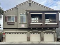 Charming townhome with three garage doors, stucco siding, and quaint Juliet balconies at 2150 W Alameda Rd # 2139, Phoenix, AZ 85085