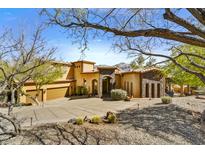 Elegant stucco home featuring a spacious driveway and beautiful desert landscaping at 4367 S Avenida De Angeles --, Gold Canyon, AZ 85118