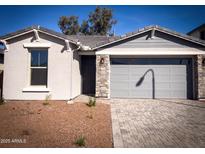 Charming single-story home featuring a stone-accented facade and a well-maintained, neutral-toned exterior at 5414 W Las Palmaritas Dr, Glendale, AZ 85302