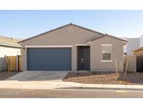 Newly constructed home with a two-car garage and desert landscaping at 9115 N 173Rd Ln, Waddell, AZ 85355