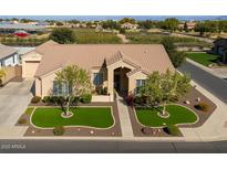 Attractive single-story home featuring manicured lawns, trees, and a tile roof at 21774 E Camacho Rd, Queen Creek, AZ 85142