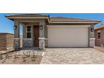 Charming single-Gathering home featuring a front door, two-car garage, and a well-maintained, professionally-designed paver driveway at 5649 N 205Th Ln, Buckeye, AZ 85396