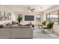 Bright living room featuring a comfy sectional sofa and large windows at 1211 E Torrey Pines Ln, Chandler, AZ 85249