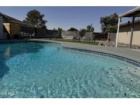 Inviting backyard pool with ample patio space, perfect for relaxing and entertaining outdoors at 5625 W Grovers Ave, Glendale, AZ 85308