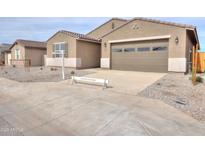 Charming single-story home featuring a two-car garage, desert landscaping, and neutral-toned exterior at 36834 W La Paz St, Maricopa, AZ 85138