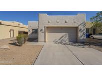 Charming home featuring a two-car garage and well-maintained desert landscaping at 3948 W Salter Dr, Glendale, AZ 85308