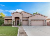 Beautiful two-story home with stone accents and a landscaped lawn at 1239 E Kramer Cir, Mesa, AZ 85203