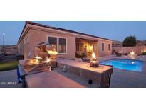 Outdoor kitchen, pool, and patio with fire features at 12866 S 183Rd Ave, Goodyear, AZ 85338