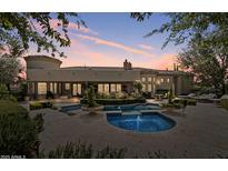 Stunning backyard pool and spa with lush landscaping, perfect for outdoor entertaining and relaxation at 6322 E Turquoise Ave, Paradise Valley, AZ 85253