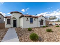 Single-story home with Spanish-style architecture, walkway, and landscaped yard at 2955 N Augustine --, Mesa, AZ 85207