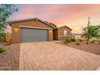 Single-story home with gray garage door and landscaped yard at 4969 W Beckham Way, San Tan Valley, AZ 85144