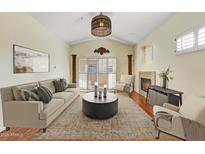 Bright living room featuring elegant decor, fireplace, and sliding glass door at 8653 E Royal Palm Rd # 2005, Scottsdale, AZ 85258
