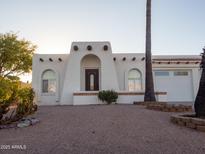 Charming home with arched windows, stucco facade, and desert landscaping for a unique southwestern curb appeal at 14211 N Fountain Hills Blvd # B, Fountain Hills, AZ 85268