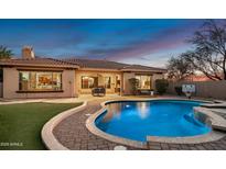 Stunning backyard oasis featuring a sparkling pool, patio, and lush landscaping at 1840 W Sierra Sunset Trl, Phoenix, AZ 85085