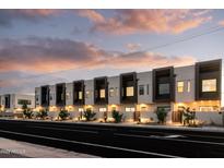 Modern townhome community with attached garages and landscaped street view at 4050 N 12Th St # 4, Phoenix, AZ 85014