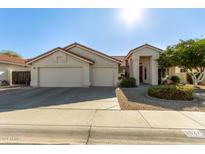 Single-story home with two-car garage and landscaped front yard at 5827 W Charter Oak Rd, Glendale, AZ 85304