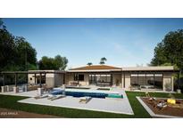 Luxury backyard oasis featuring a pool, outdoor kitchen, and fire pit at 23002 N Country Club Trl Trl, Scottsdale, AZ 85255