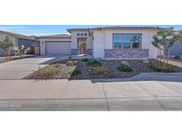 Single-story home with a two-car garage and desert landscaping at 13487 W Roy Rogers Rd, Peoria, AZ 85383