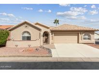 Charming single-story home with well-maintained landscaping and two car garage at 1560 E Riviera Dr, Chandler, AZ 85249