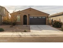 Single-story home with a two-car garage and desert landscaping at 35907 W San Clemente Ave, Maricopa, AZ 85138