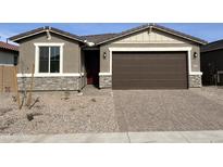 Charming single-story home with a two-car garage and stone accents, offering modern curb appeal at 40010 W Elm Dr, Maricopa, AZ 85138