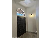 Elegant entryway with double doors and skylight at 7955 E Chaparral Rd # 103, Scottsdale, AZ 85250