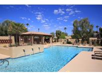 Inviting community pool with a relaxing patio area at 7955 E Chaparral Rd # 103, Scottsdale, AZ 85250