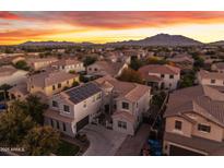 Luxury home with solar panels, stunning sunset views, and mountain backdrop at 3121 E Powell Way, Gilbert, AZ 85298