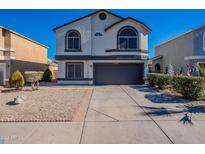 Two-story house with a two-car garage and landscaped front yard at 7313 N 69Th Ave, Glendale, AZ 85303