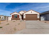 Single-story house with brown garage door and landscaping at 7280 E White Tail Rd, San Tan Valley, AZ 85143