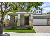 Craftsman style home with stone accents and a two-car garage at 10605 E Monterey Ave, Mesa, AZ 85209