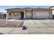 One-story house with a two-car garage and desert landscaping at 14953 W Cortez St, Surprise, AZ 85379