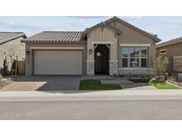 Charming single-story home featuring stone accents, a two-car garage, and well-maintained landscaping at 32994 N 131St Dr, Peoria, AZ 85383