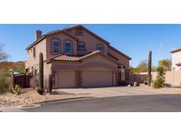 Inviting two-story home boasts a spacious three-car garage and desert landscaping at 3650 N Barron --, Mesa, AZ 85207