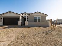 Gray house with a two-car garage and a walkway to the entrance at 4045 S 177Th Ln, Goodyear, AZ 85338