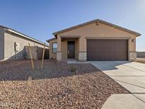 New single-story home with a two-car garage and desert landscaping at 9109 N 173Rd Ln, Waddell, AZ 85355