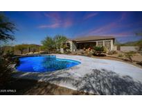 Inviting backyard oasis featuring a sparkling pool and expansive patio at 3701 E Sat Nam Way, Cave Creek, AZ 85331