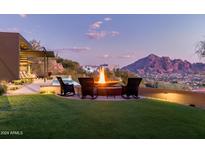 Backyard with firepit and seating area, offering stunning mountain views at 4060 E Lamar Rd, Paradise Valley, AZ 85253