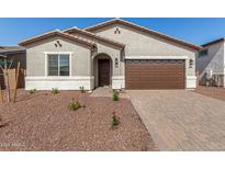 Charming single-story home showcasing a stone driveway and low maintenance desert landscaping at 17586 W Blue Sky Dr, Surprise, AZ 85387