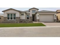 Beautiful single Gathering home with stone accents, manicured lawn, and welcoming curb appeal at 21627 W Mariposa St, Buckeye, AZ 85396
