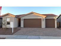 Charming home featuring a three-car garage and a tile roof at 17868 W Blue Sky Dr, Surprise, AZ 85387