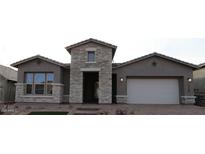 Beautiful single-story home featuring a stone facade, a two-car garage, and desert landscaping at 32521 N 135Th Dr, Peoria, AZ 85383