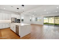 Spacious kitchen with island, stainless steel appliances, and white cabinets at 1310 E Beechnut Pl, Chandler, AZ 85249