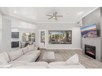 Spacious living room featuring hardwood floors, fireplace, and large window at 32427 N 71St Way, Scottsdale, AZ 85266