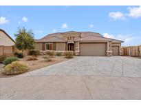 Beautiful two-story home with a three-car garage and desert landscaping at 5531 W Gwen St, Laveen, AZ 85339