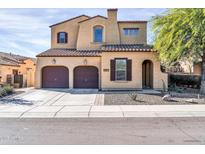 Two-story house with Spanish-style architecture, two-car garage, and landscaping at 13653 W Jesse Red Dr, Peoria, AZ 85383